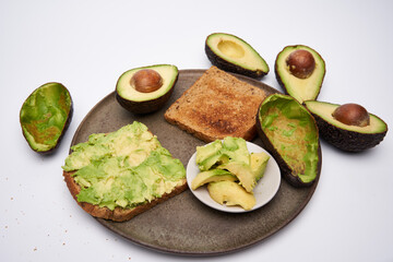 Fresh avocado on toast on white background