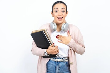 Young beautiful woman smiles toothily cannot believe eyes expresses good emotions and surprisement