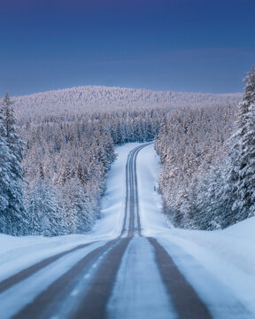 Lapland in winter with large amount of snow during colourful sunset