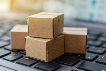 Boxes with parcels stand against the background of the keyboard. Online delivery and online shopping concept