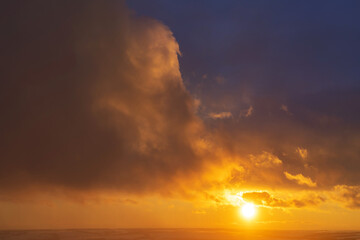 winter evening, sunset in yellow, orange and pink with clouds, background