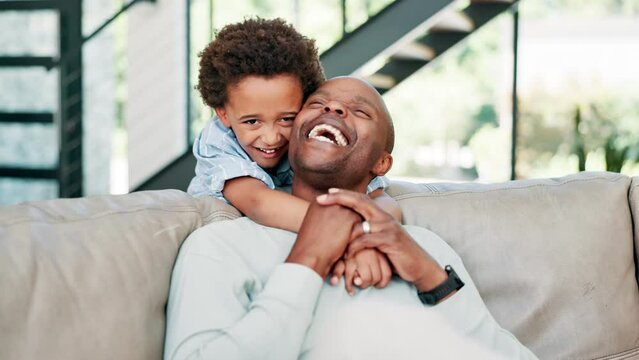 Happy dad, child and hug on sofa for love, support or care in fun bonding, holiday or weekend together at home. African father, kid or son smile for embrace, relax and sitting on living room couch