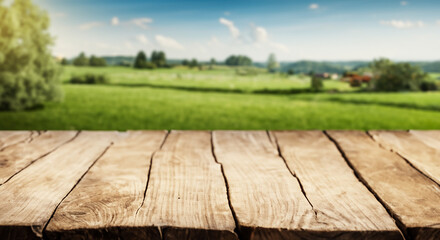 Wooden table surrounded by lush green grass under a bright blue sky in a serene meadow, capturing...
