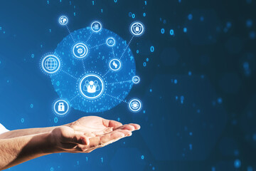 Close up of businessman hands holding creative connected digital business interface with various icons and binary code on blurry background. Software development, app, global business and ai concept.