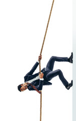 Hardworking young businessman climbing a rope on a transparent background