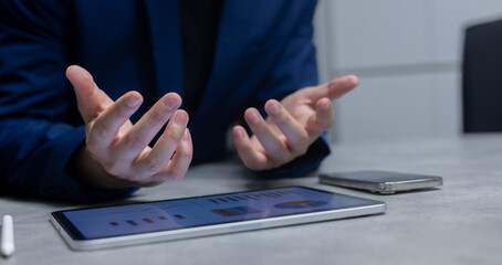 close up businessman hand gesture to explain about summary chart dashboard screen on digital tablet...