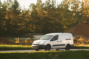 A commercial van truck on the highway, delivering goods and products across the country, using fast and reliable modes of freight transportation.