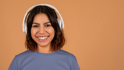 Closeup of middle eastern lady using wireless headphones