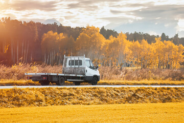 Tow Truck Transporter on the Highway. Road side assistance. A Car Carrier Tow Truck Driving Fast on...