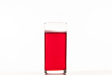 Business lunch. Berry juice in a glass on a white background