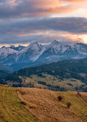 Autumn mountains landscape. Beautiful autumn with trees under the Tatra Mountains at sunrise. Sun moutain forest fog landscape at sunset on meadow.