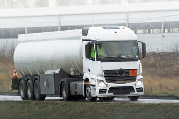 A White Tank Truck on the road Delivering Goods Safely including liquid petroleum gas LPG or propane.