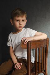 blond boy in a white T-shirt, blurred background, bokeh