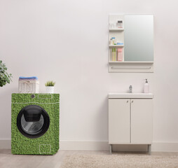 Energy efficient green washing machine in a bathroom