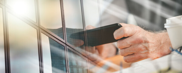 Hands using mobile phone; multiple exposure