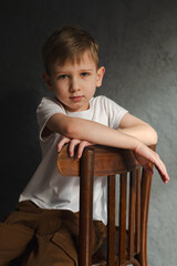 blond boy in a white T-shirt, blurred background, bokeh