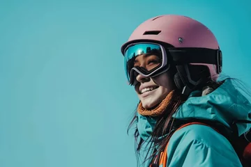 Fotobehang Young smiling woman wear warm padded windbreaker jacket hat ski goggles mask hold snowboard look aside on area travel rest spend weekend winter season in mountains isolated on plain blue background © Khalif