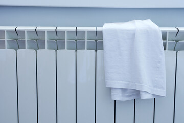 White clothes hanging on the radiator in the room.
Heating season, drying laundry.