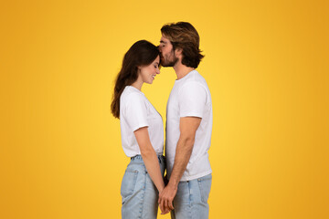 Happy young caucasian man kiss at forehead woman in white t-shirt, enjoy date
