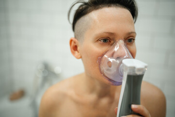 A woman is treated for a respiratory throat disease and wears a special cooking device in the...