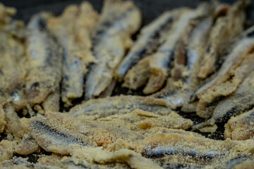 flour coated anchovy pan dish in pan ready for cooking close up