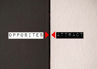 Contrast wall with text written OPPOSITES ATTRACT - means different type of people are often...