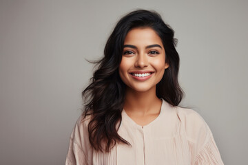 Portrait of a smiling young woman of Indian ethnicity
 - obrazy, fototapety, plakaty