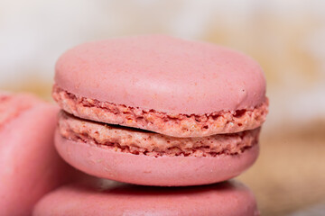 Obraz na płótnie Canvas Pink macarons up close. Perfect for banners, kitchen decor, or pastry shops.