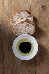 Slices of rustic bread on an old wooden table.
