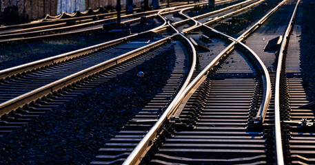 Railway track panorama with high contrast at evening twilight. Reflecting and glistening rails,...