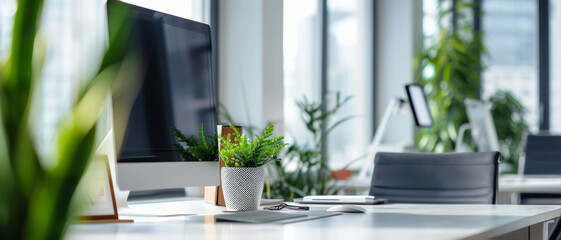 Contemporary office space bathed in natural light, featuring a sleek computer monitor and vibrant houseplants - obrazy, fototapety, plakaty