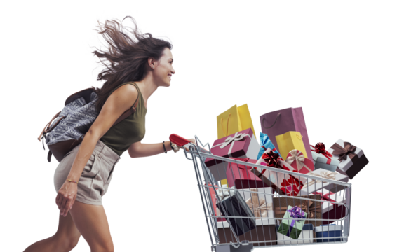 Happy woman pushing a shopping cart full of gifts