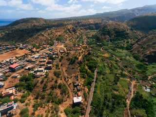 Obraz premium Barragem Principal in Santiago Island, Cape Verde, water dam view from the top of the mountain, view of the sea, mountains and small village.