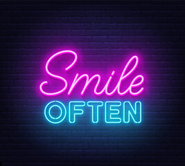 Smile Often neon lettering on brick wall background