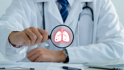Doctor holding magnifying glass to checkup lung health,respiratory disease,lung...