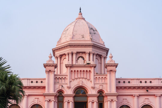 Detail view of the pink facade and dome of historic Ahsan Manzil palace with blue sky background, Kumartoli, Dhaka, Bangladesh