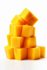 mango cubes on a white background. a stack of pieces of ripe tropical fruit.