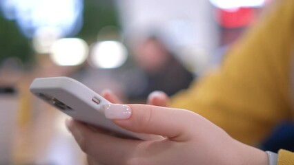 Young woman using smartphone at mall. Caucasian girl looking at mobile phone. Communication, work or study, connection, mobile apps, technology, lifestyle concept 4K - Powered by Adobe