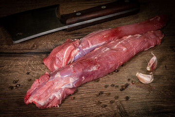 Side view Close up denver Steak, Flank steak, cut near denver alternative beef steak and a cleaver butcher meat knife a rustic metall background selective focus