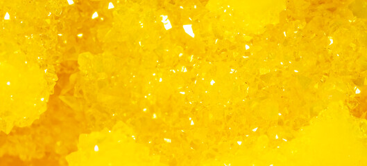 Golden crystal mineral stone. Gems. Mineral crystals in the natural environment. Texture of precious and semiprecious stones. Seamless background with copy space.