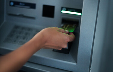 Woman using banking machine