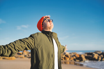 Free and happy man with open arms enjoying nature - Happy Caucasian boy outdoors breathing fresh air - Concept of enjoyment, freedom, happiness and mental health.