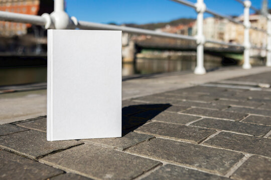 Book with a blank cover to be able to write text or change the cover perched next to the Bilbao estuary, in Spain