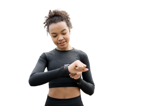 A young female fitness trainer is using a fitness tracker to monitor the progress of her workout. The background is a clear, empty space.