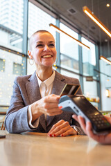 Portrait Happy woman holding a credit card and making a payment transaction.