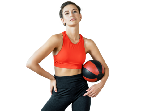 A young athletic confident female trainer with a fitness ball in a tracksuit. Isolated transparent background.