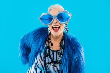 Happy and funny senior old woman wearing fashinable clothing on colorful background- Modern cool...