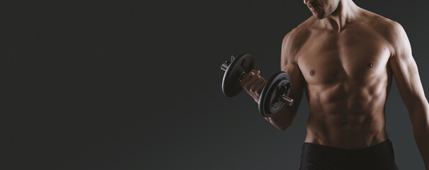 Handsome fit man holding a barbell and working out