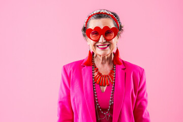 Happy and funny senior old woman wearing fashinable clothing on colorful background- Modern cool...