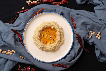 traditional homemade hummus. blue fabric background.
